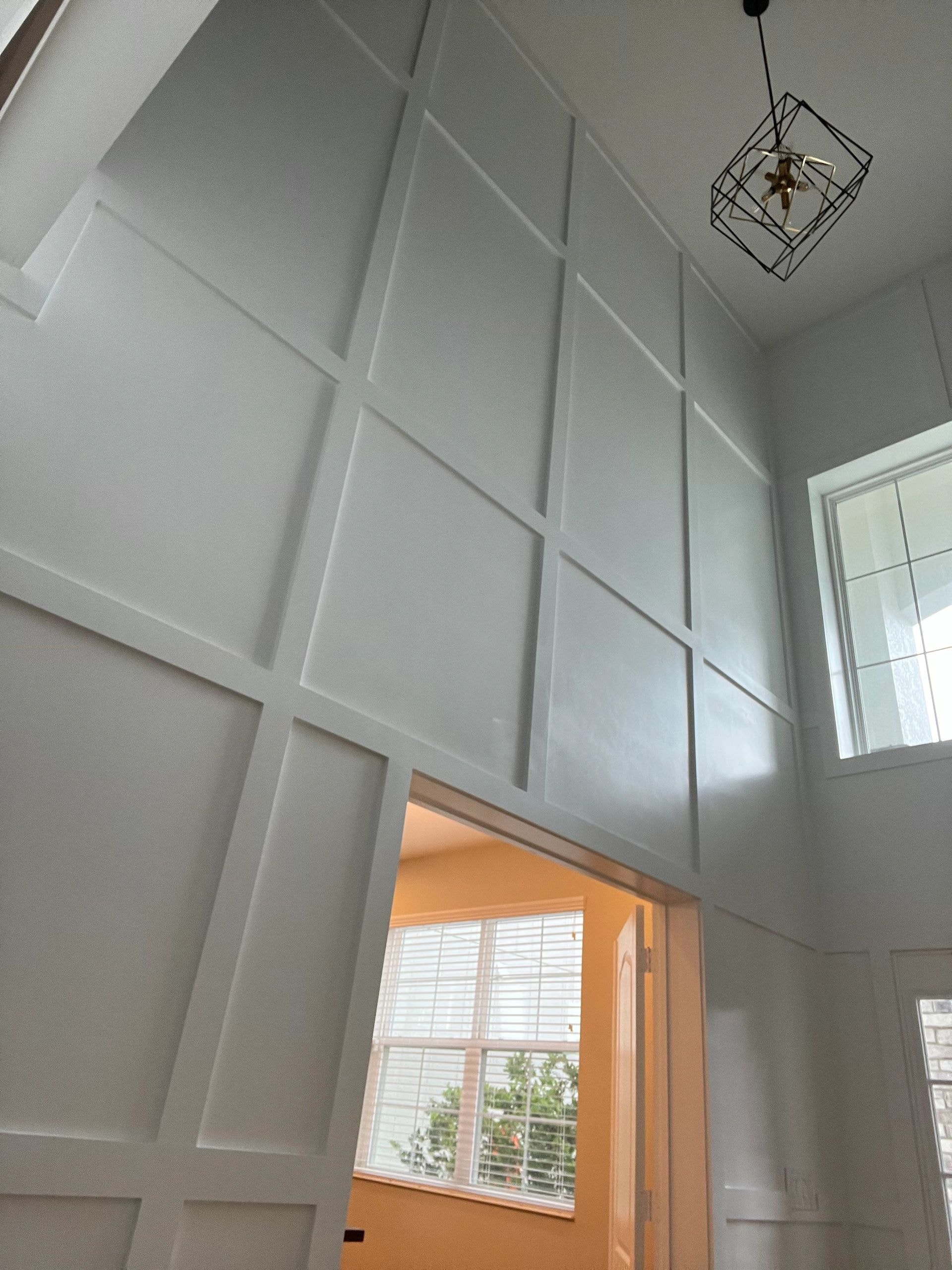 Modern entryway with white shiplap wall paneling